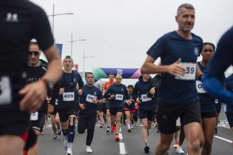 Runners take part in a race on the tarmac to celebrate the Games at Paris Aéroport.