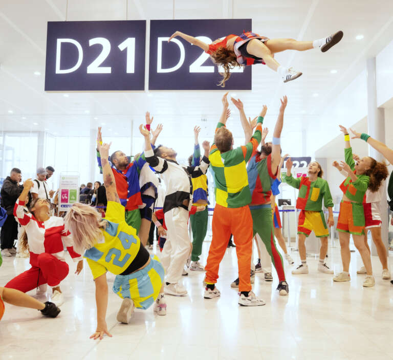 Colorful dance performance in an airport terminal