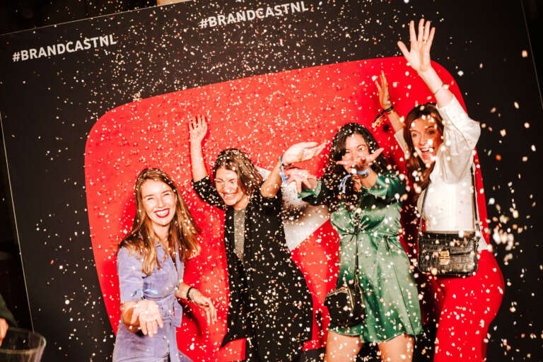 Festive event entertainment at a YouTube stand, with a shower of confetti and enthusiastic participants