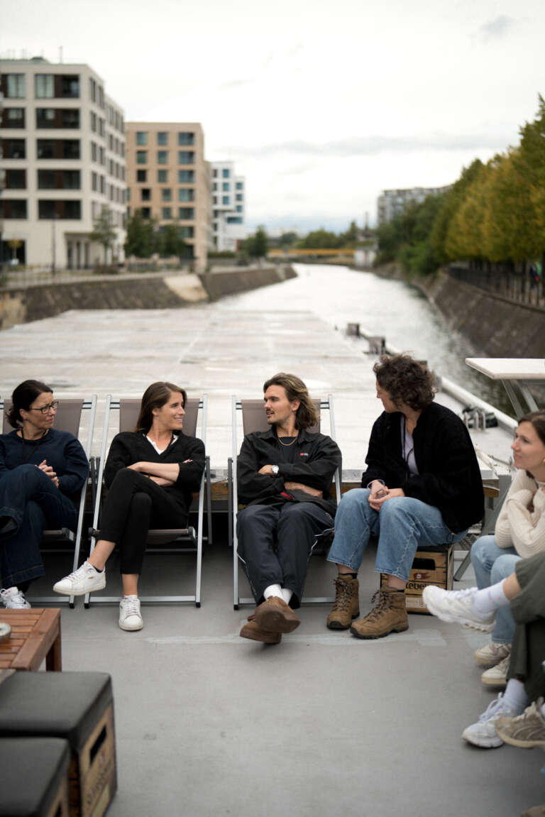 Informal exchange between OVAL employees in a natural setting, embodying kindness on a daily basis